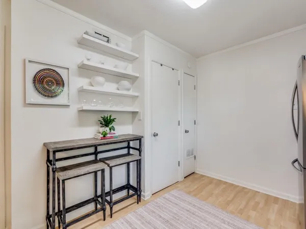 a view of a hallway with workspace and wooden floor