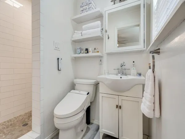a bathroom with a sink toilet and shower