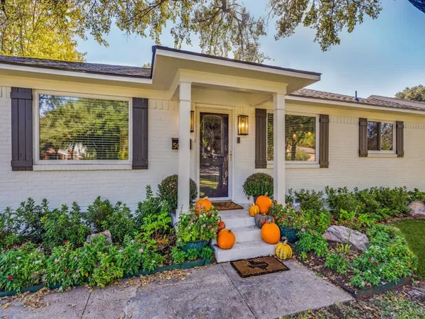 front view of a house with potted plants