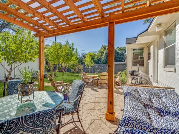 a view of a patio with table and chairs and potted plants