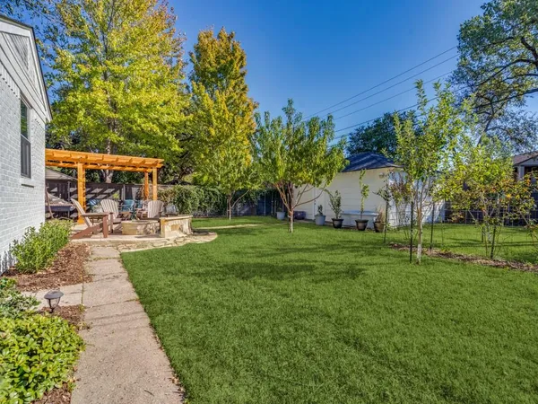 a view of a patio with a table and chairs under an umbrella
