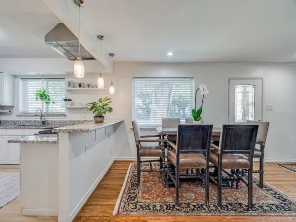 a view of a dining room with furniture and window