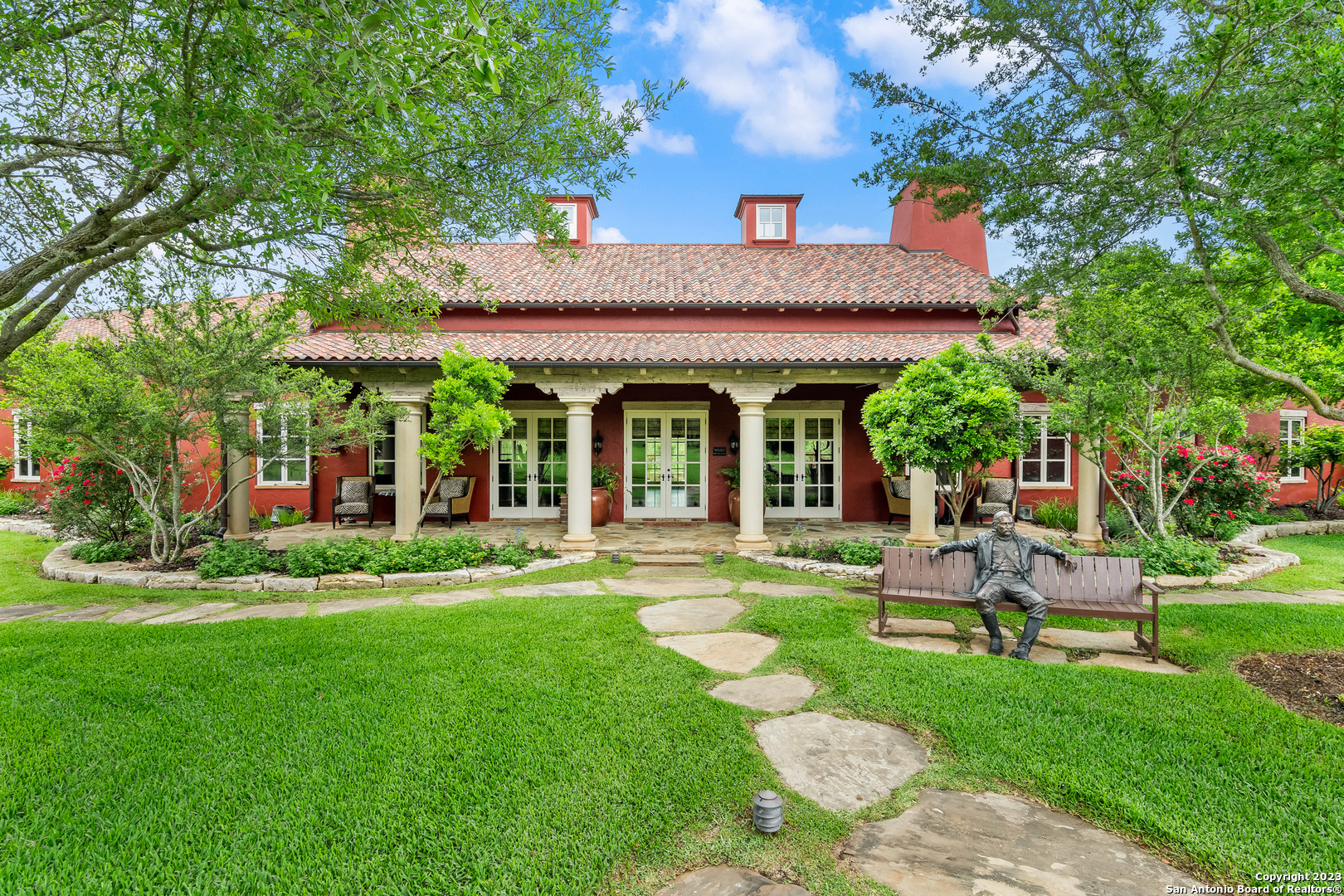124 Highway 46 Boerne, TX 78006 - Photo 20 of 32 a view of a house with a yard fire pit and a large tree