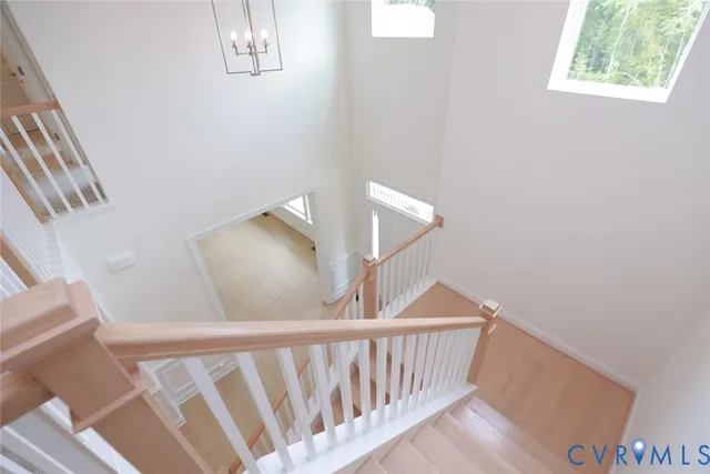a view of staircase with railing and white walls