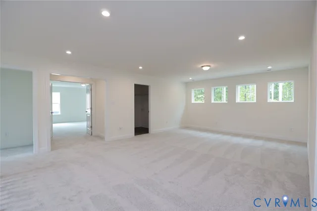 an empty room with windows and entrance