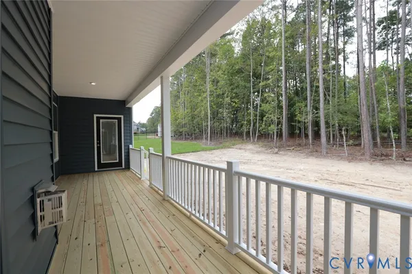 a view of backyard with green space and wooden fence