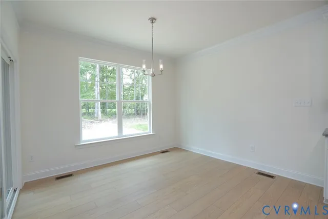 a view of an empty room with windows