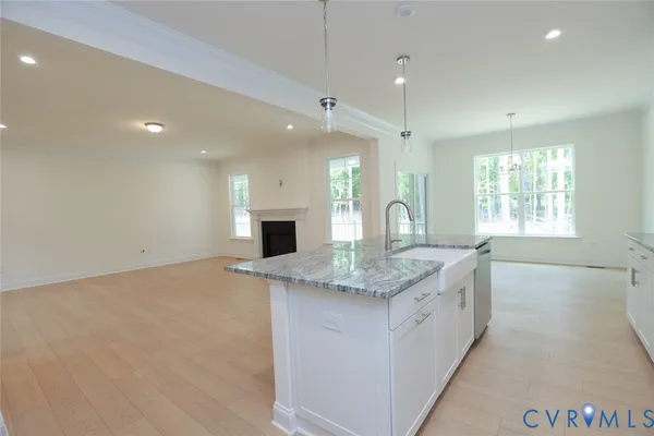 a kitchen with granite countertop a sink and window