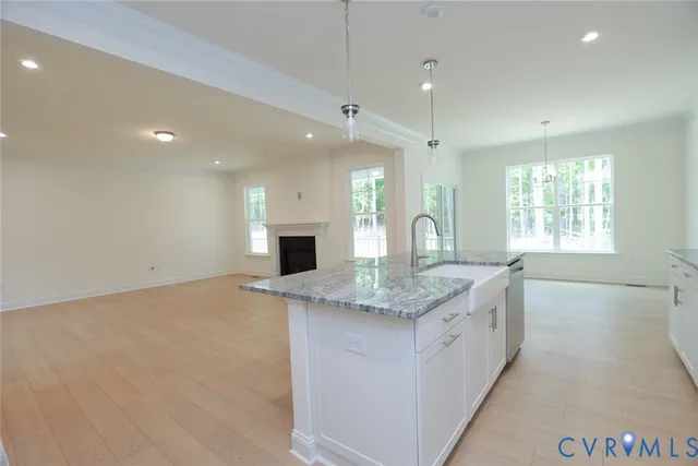 a kitchen with granite countertop a sink and window