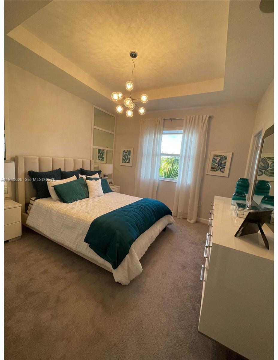 1879 Southeast 27th Street Homestead, FL 33035 - Photo 5 of 10 a bedroom with a bed window and couch
