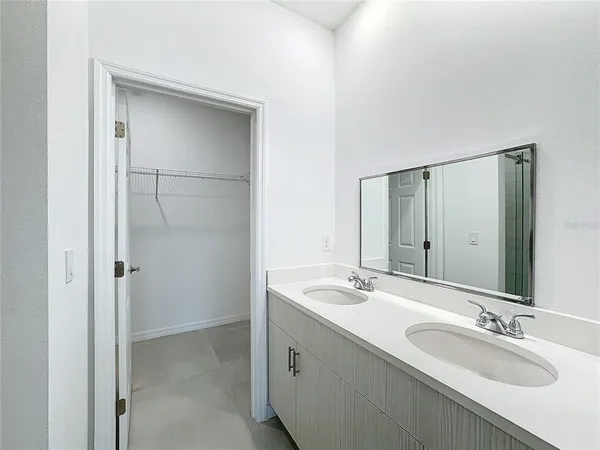 an empty room with a bathroom and a sink