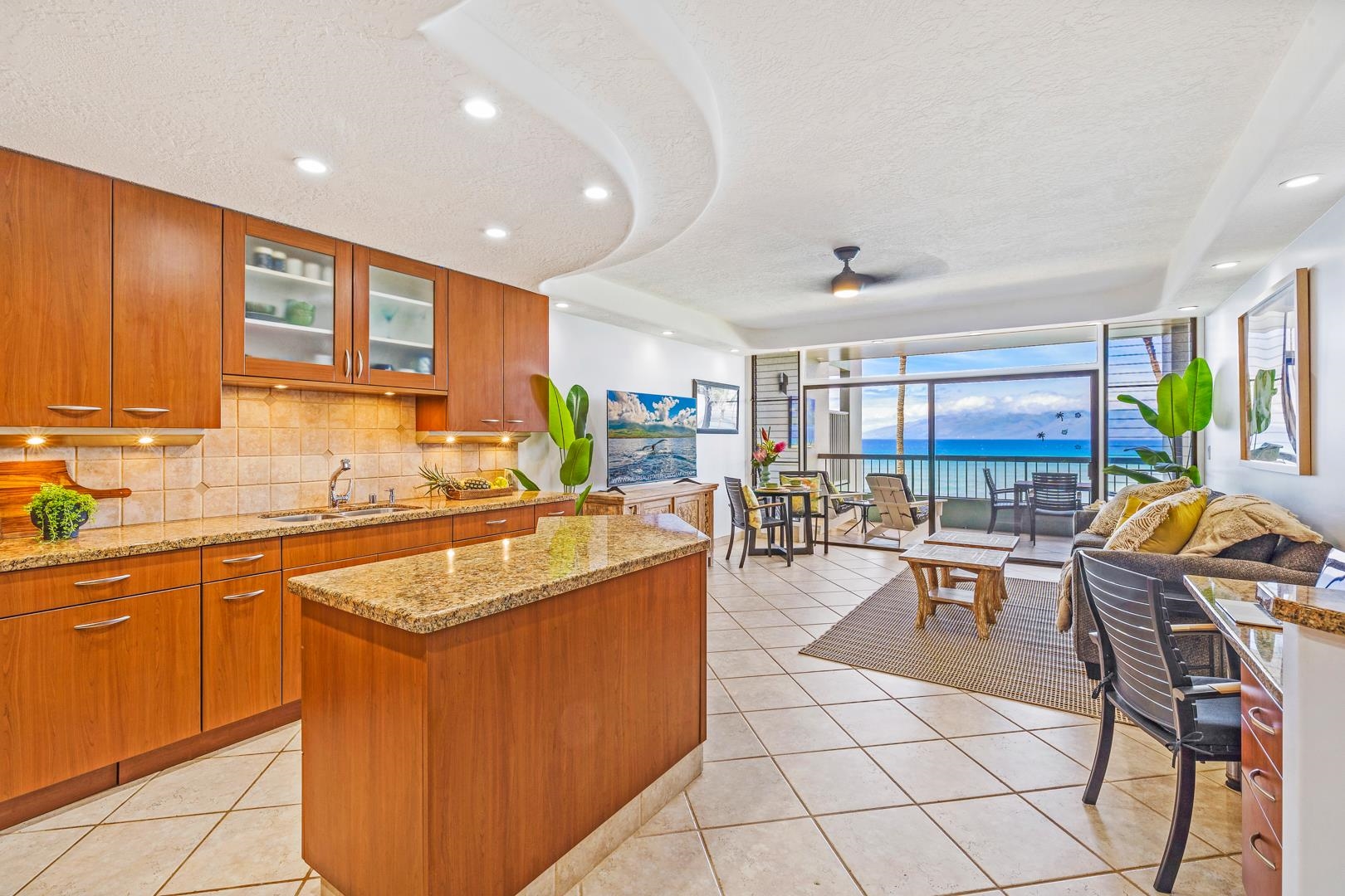 3875 Lower Honoapiilani Road, Unit B305 Lahaina, HI 96761 - Photo 2 of 35 a kitchen with stainless steel appliances granite countertop a table chairs and a sink