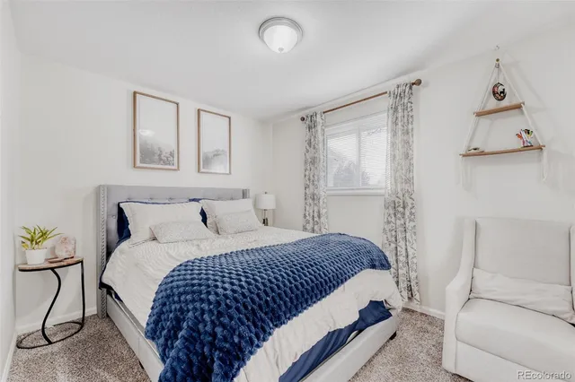 a bedroom with a bed and chair