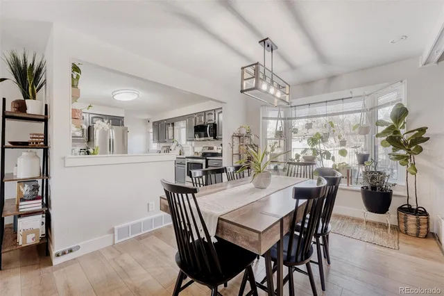 a view of a dining room with furniture and wooden floor