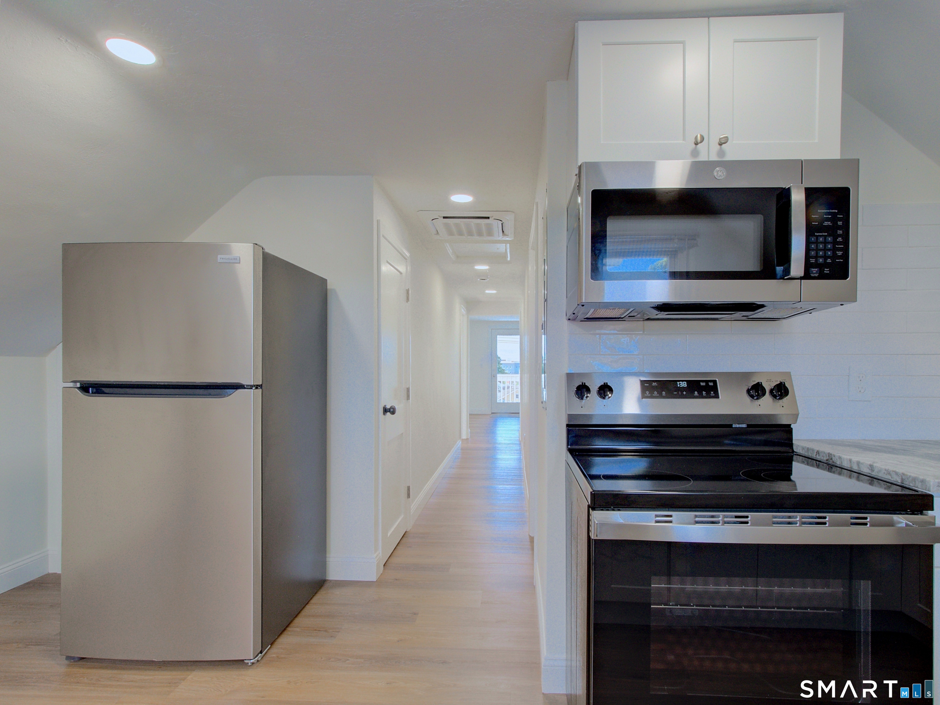 16 Benham Road, Unit D Groton, CT 06340 - Photo 7 of 15 a kitchen with stainless steel appliances a refrigerator and a stove top oven