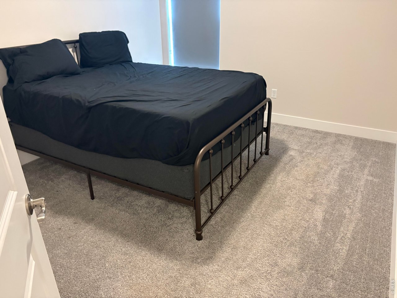 102 7th Avenue Wiggins, CO 80654 - Photo 14 of 17 a bedroom with a bed and a dresser