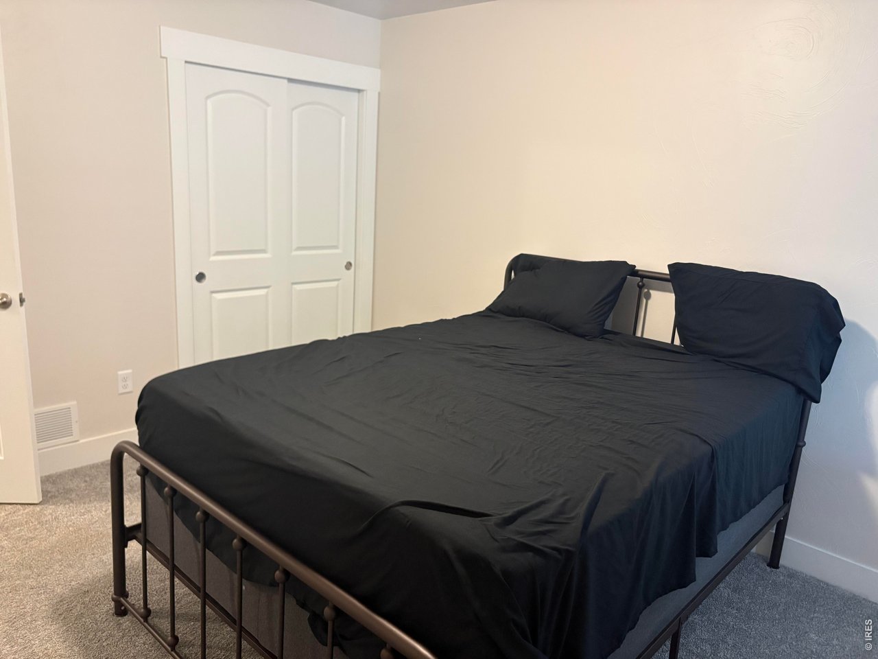 102 7th Avenue Wiggins, CO 80654 - Photo 15 of 17 a bedroom with a bed and dresser