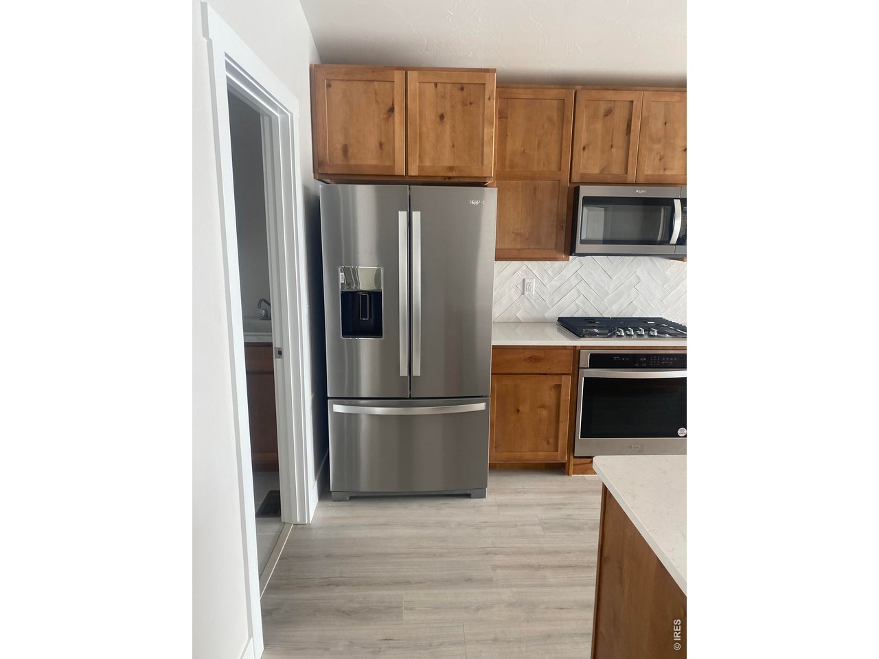 102 7th Avenue Wiggins, CO 80654 - Photo 2 of 17 a kitchen with stainless steel appliances granite countertop a refrigerator and a stove
