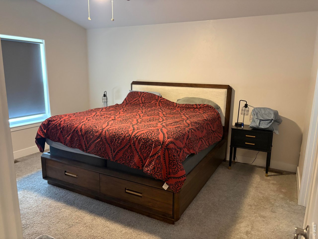102 7th Avenue Wiggins, CO 80654 - Photo 8 of 17 a bed sitting in a bedroom next to a lamp