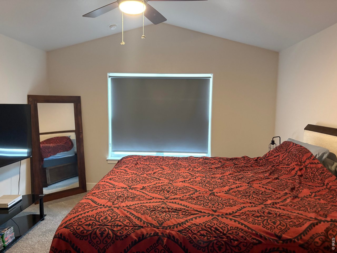 102 7th Avenue Wiggins, CO 80654 - Photo 9 of 17 a bedroom with a bed and a flat screen tv