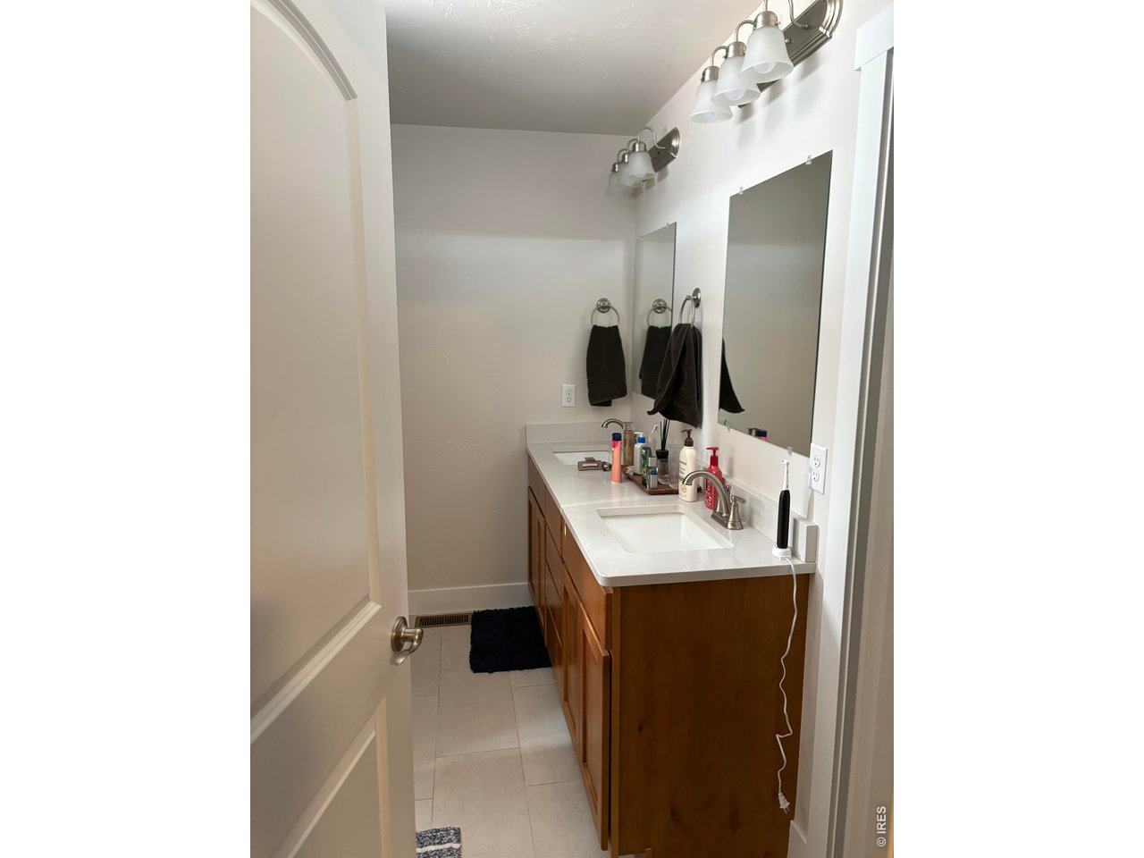 102 7th Avenue Wiggins, CO 80654 - Photo 10 of 17 a bathroom with a sink and a mirror
