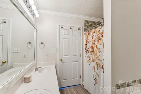 a bathroom with a tub shower sink and toilet