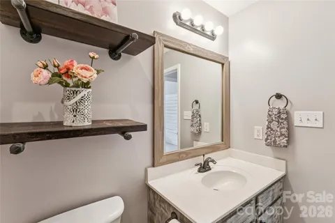 a bathroom with a sink a toilet and shower curtain