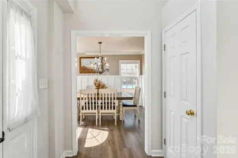 a view of dining room with wooden floor and windows