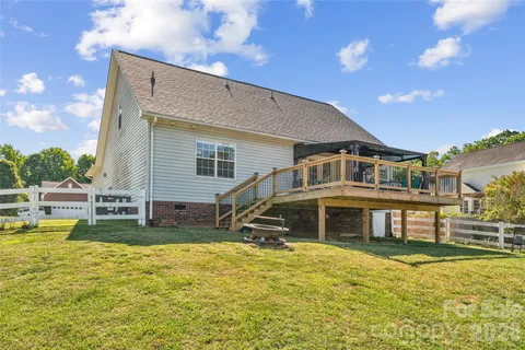 a view of a house with swimming pool and a yard