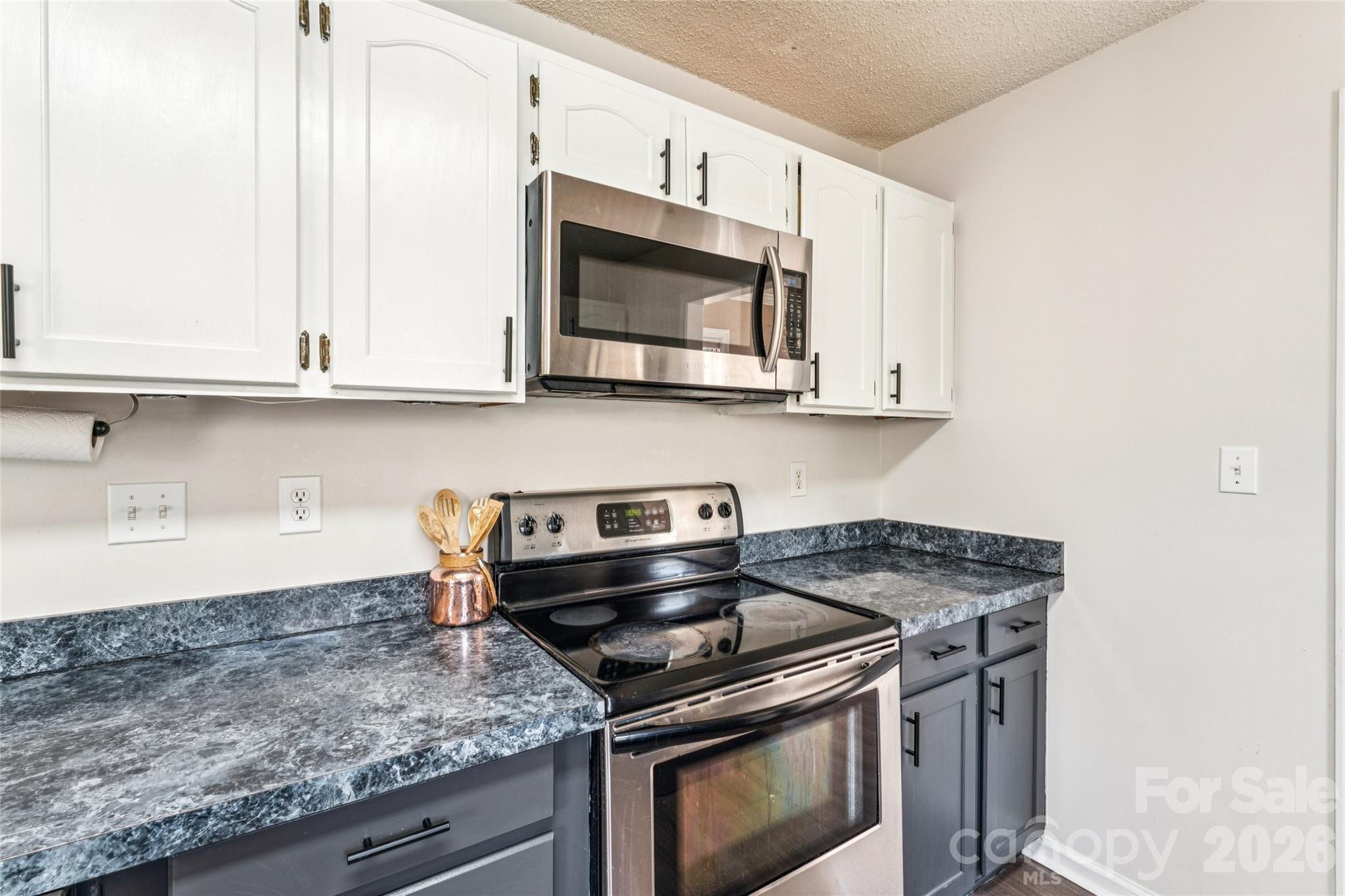 103 Quarry Way Salisbury, NC 28146 - Photo 10 of 47 a kitchen with stainless steel appliances granite countertop white cabinets and a stove top oven