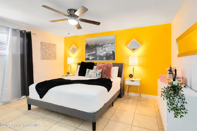 a bedroom with a bed and a chandelier