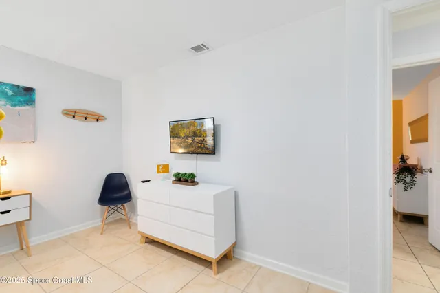 a bedroom with a bed and a lamp