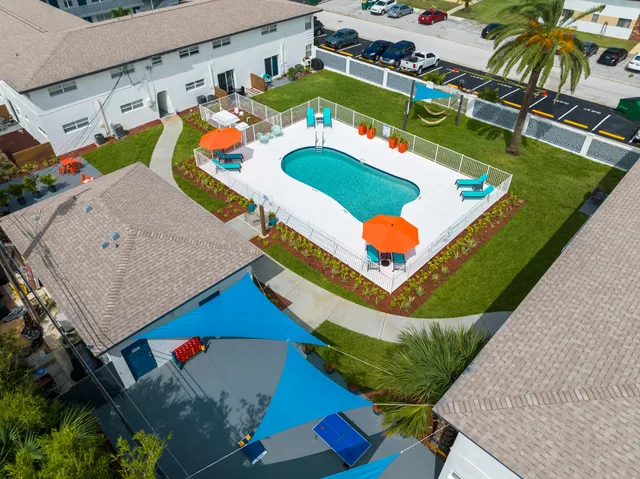an aerial view of a house a yard and outdoor seating
