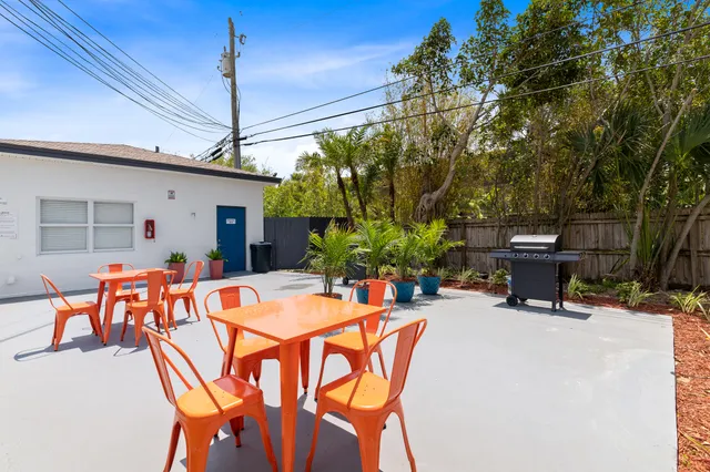 a view of a patio with table and chairs and potted plants