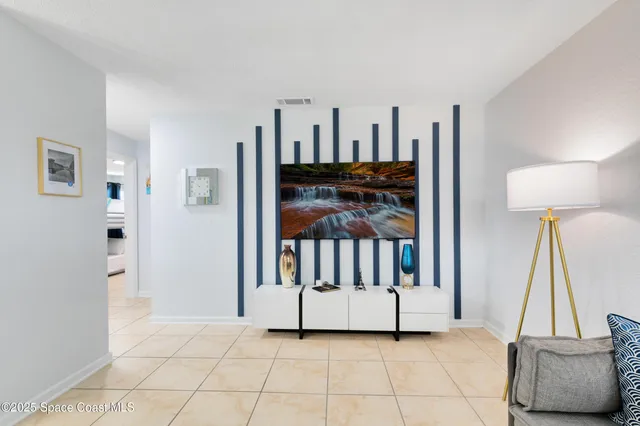 a view of a livingroom with furniture and staircase