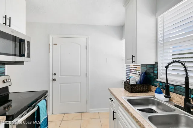 a kitchen that has a sink and a stove