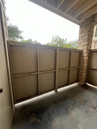 a view of a balcony with yard