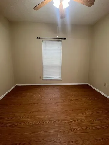 wooden floor and cabinet in an empty room