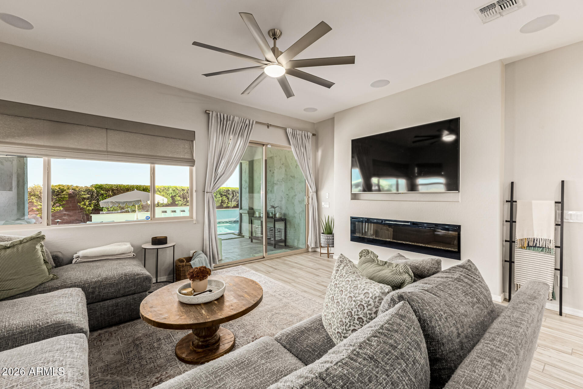 2941 South Jeffry Street Gilbert, AZ 85295 - Photo 10 of 47 a living room with furniture a flat screen tv and a large window