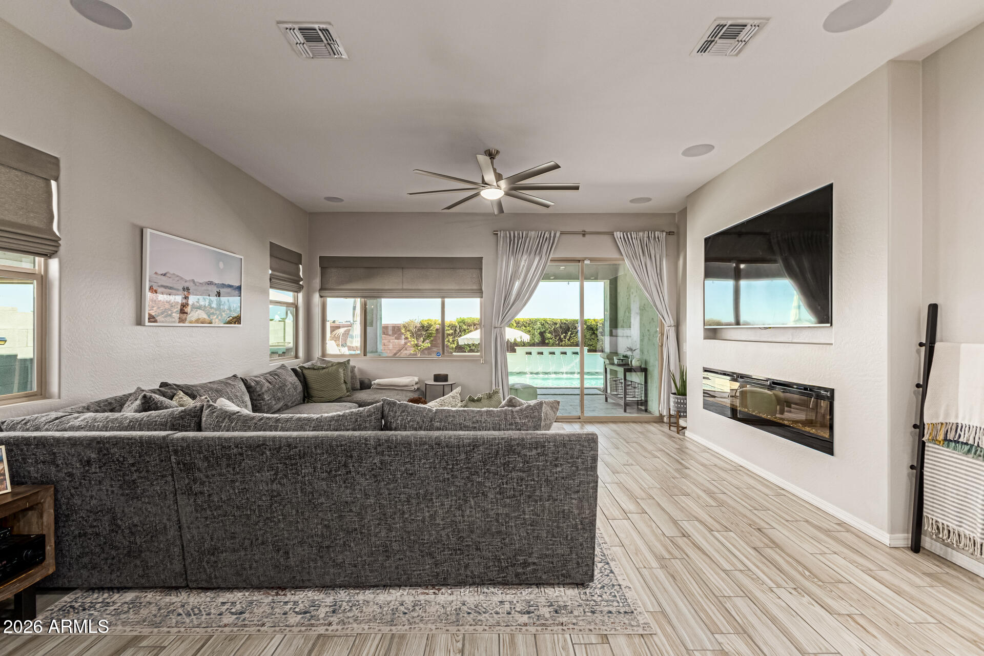 2941 South Jeffry Street Gilbert, AZ 85295 - Photo 11 of 47 a living room with furniture fireplace and flat screen tv