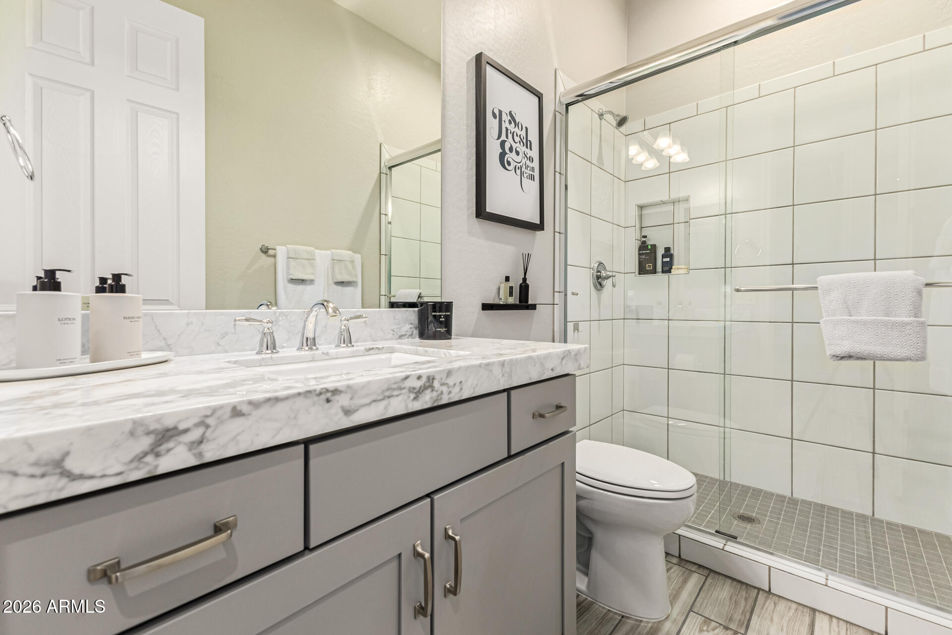 2941 South Jeffry Street Gilbert, AZ 85295 - Photo 21 of 47 a bathroom with a granite countertop sink toilet and shower