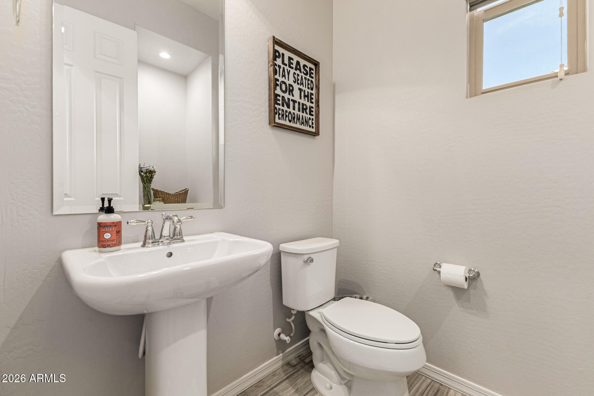2941 South Jeffry Street Gilbert, AZ 85295 - Photo 28 of 47 a bathroom with a toilet sink and mirror
