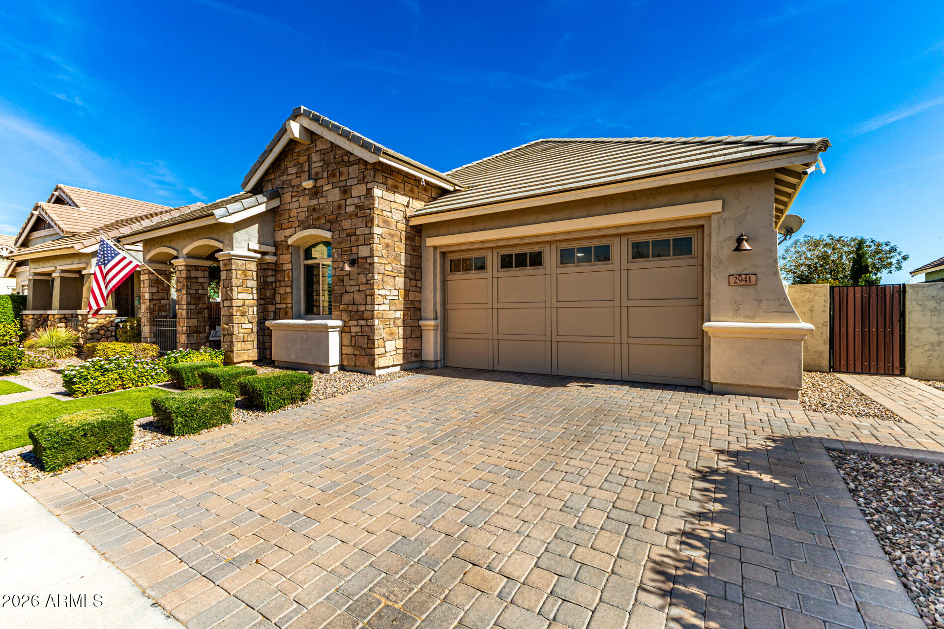 2941 South Jeffry Street Gilbert, AZ 85295 - Photo 2 of 47 a front view of a house with a yard and garage