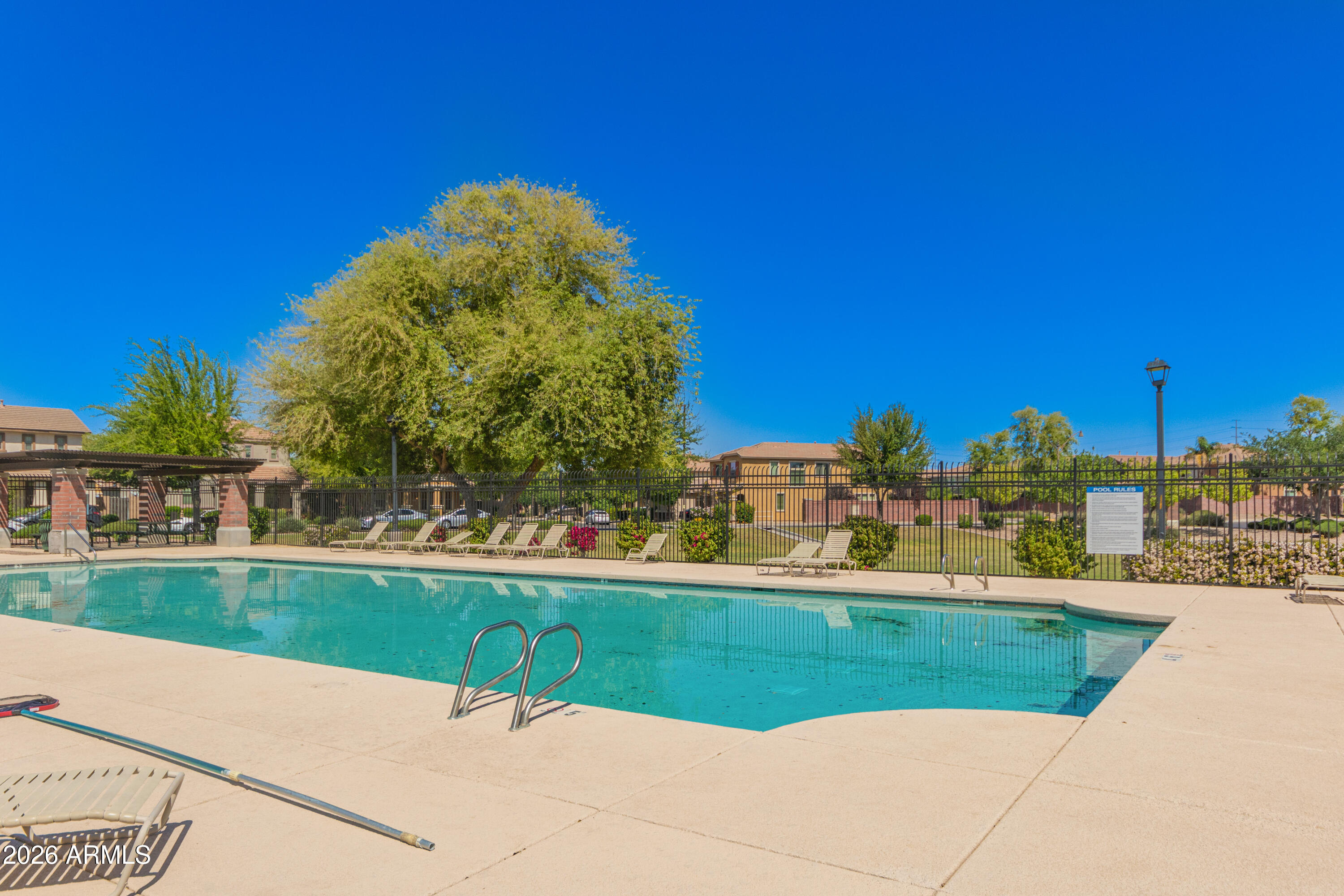 2941 South Jeffry Street Gilbert, AZ 85295 - Photo 40 of 47 a view of a swimming pool and a yard in the background