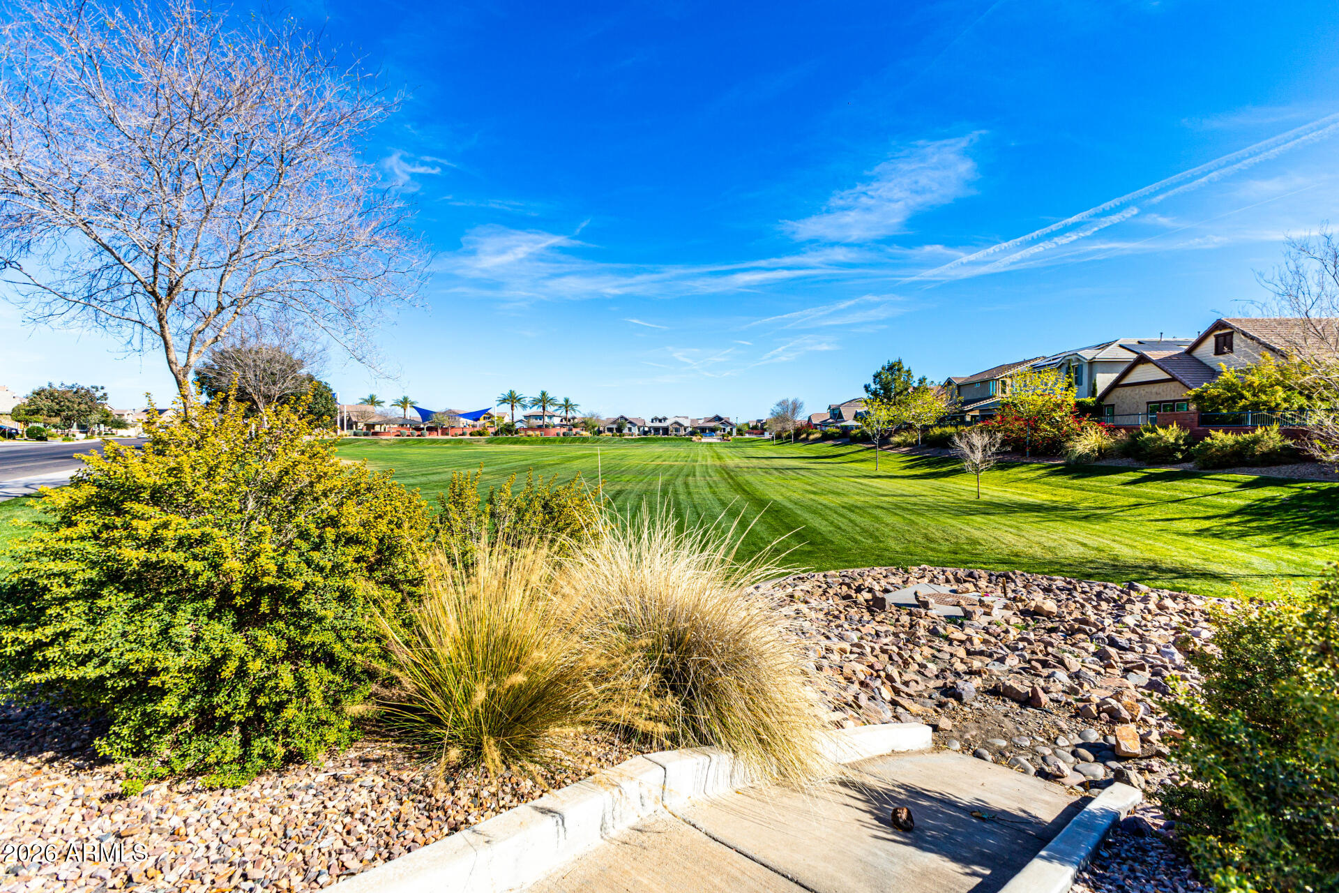 2941 South Jeffry Street Gilbert, AZ 85295 - Photo 46 of 47 a view of a lake with a house in background