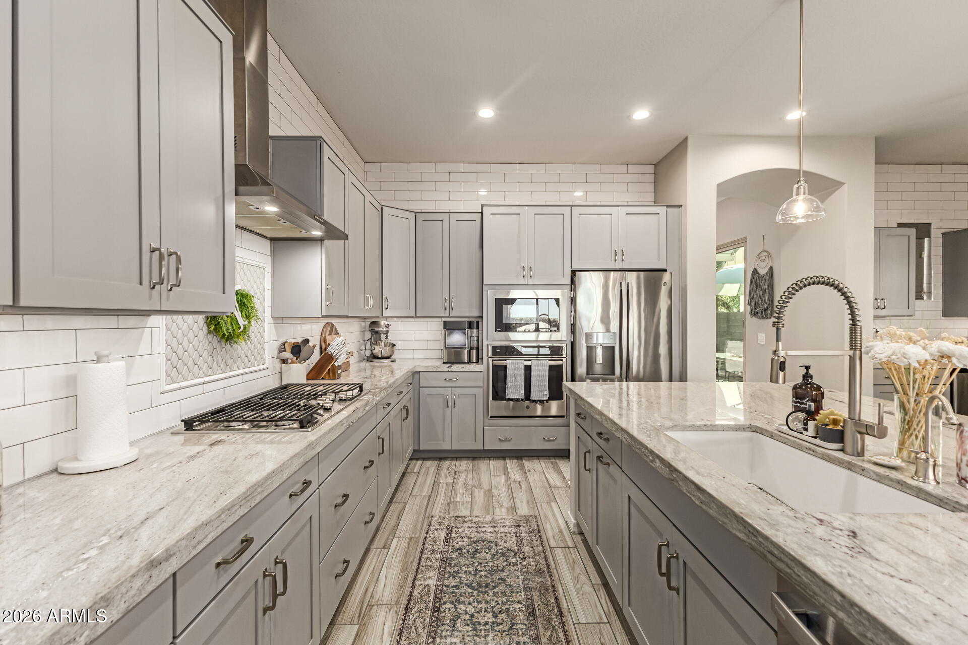 2941 South Jeffry Street Gilbert, AZ 85295 - Photo 7 of 47 a kitchen with stainless steel appliances granite countertop a sink stove and refrigerator