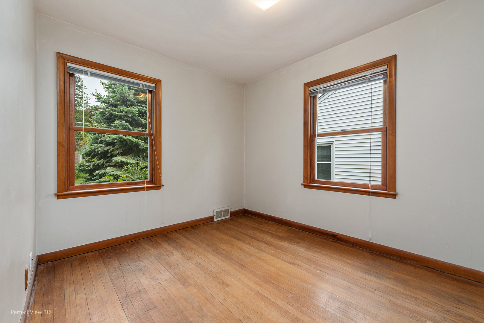 168 South Alfred Avenue Elgin, IL 60123 - Photo 6 of 15 a view of an empty room with wooden floor and a window