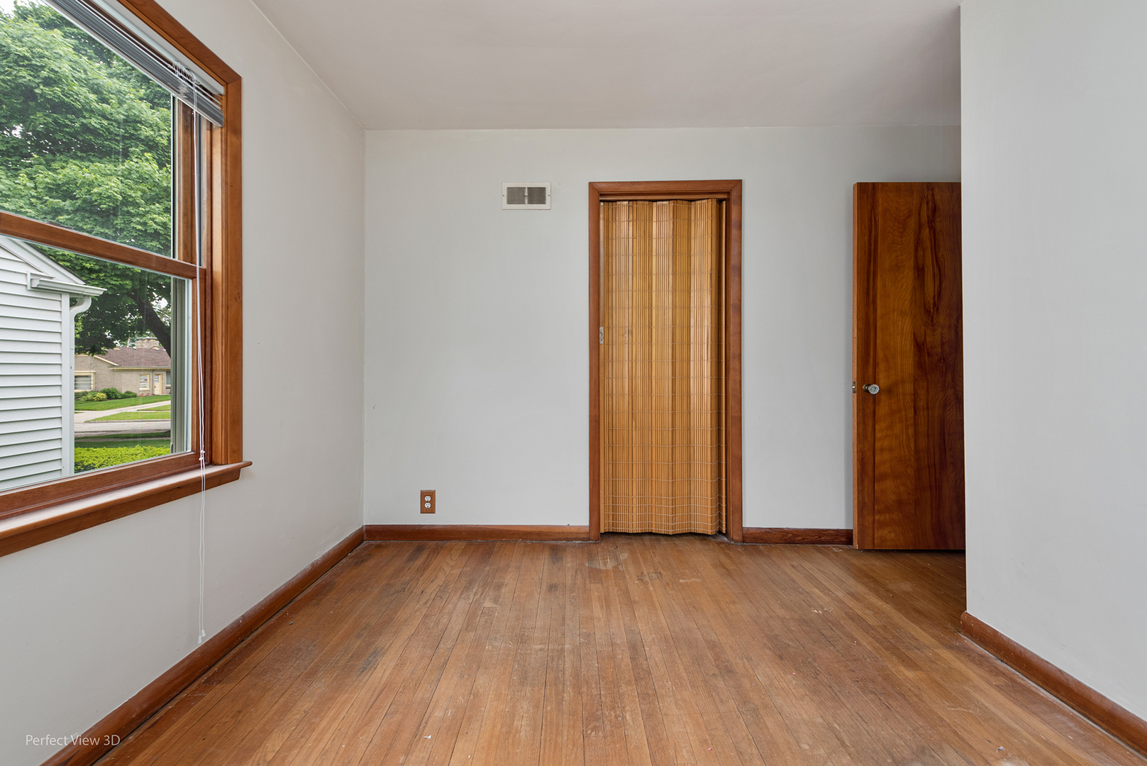 168 South Alfred Avenue Elgin, IL 60123 - Photo 7 of 15 an empty room with wooden floor and windows