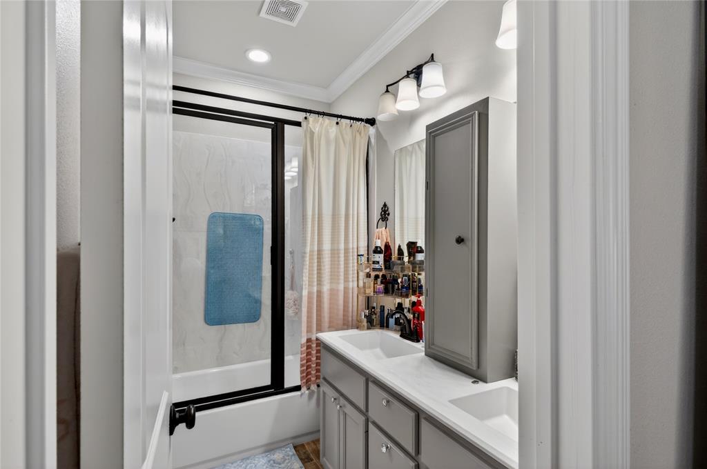 701 West Lamberth Road Sherman, TX 75092 - Photo 24 of 37 Dual vanity with integrated sinks and gray cabinetry