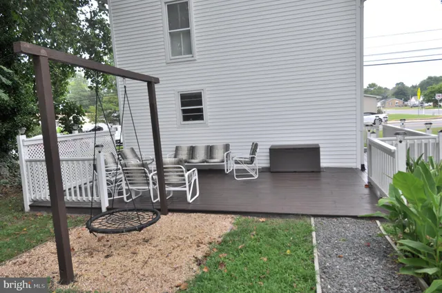 a view of a patio with chairs and potted plants